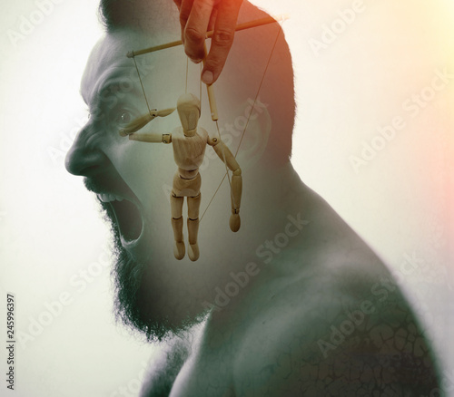 Man with marionette in his head. Concept of mind manipulation and hypnosis. Image created using double exposures. photo