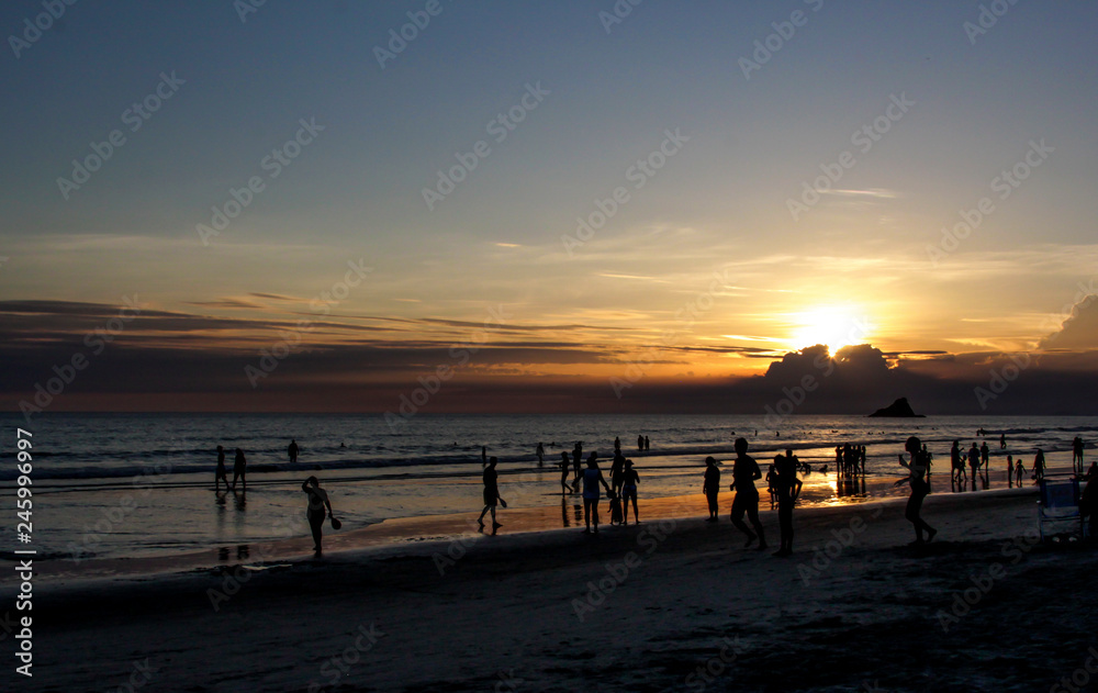 People silhouette against sunset background