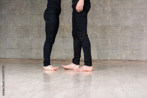 Two dancers on grey background. Young couple of dancers studying new dance over grey background, cropped image.