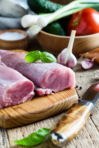 Fresh pork tenderloin, meat on wooden cutting board