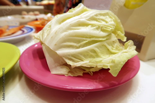 Chinese cabbage placed on a pink plate.