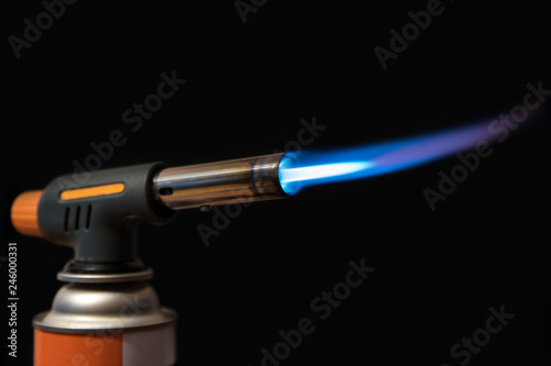 burning gas burner with propane on a black background close-up
