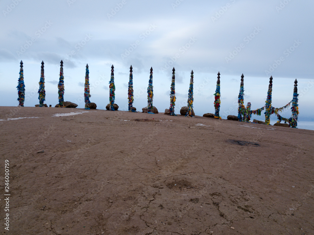 Photo of shaman poles on Olkhon island in Russia, in winter.