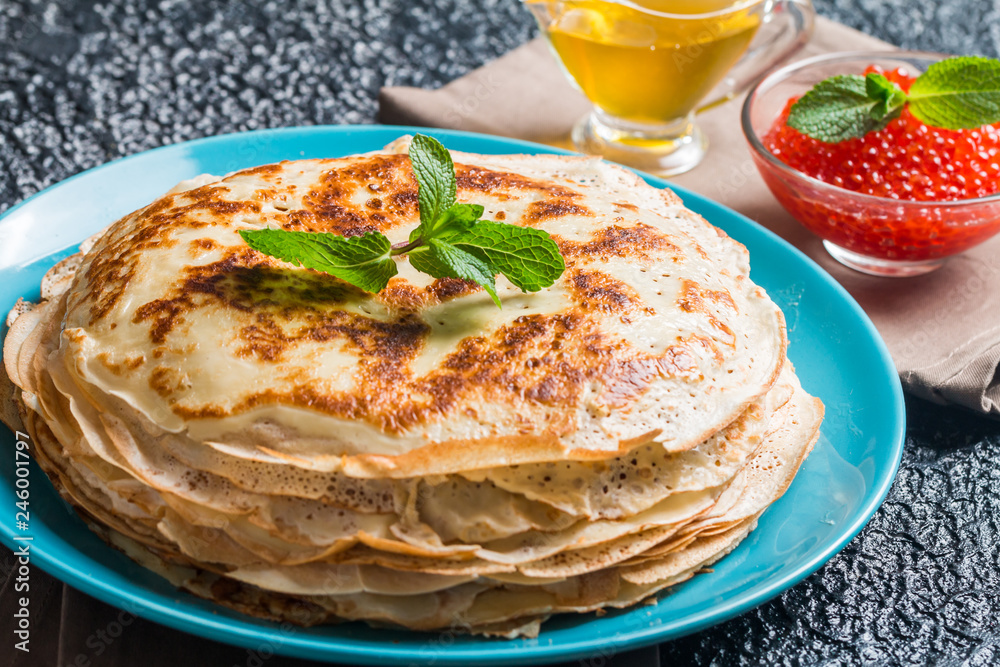 Stack of yeast pancakes, traditional for Russian pancake week witn red cavier and honey Stack of yeast pancakes, traditional for Russian pancake week witn red cavier and honey