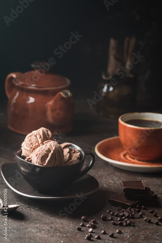 Chocolate coffee ice cream balls in a bowl over dark background