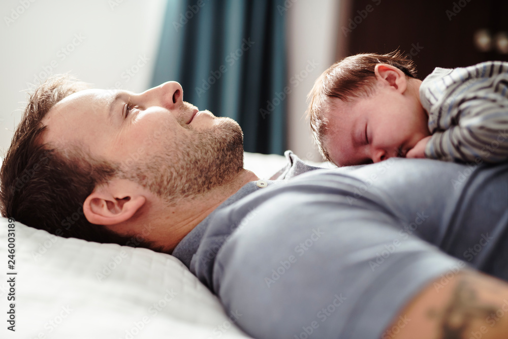 Father and Baby having wonderful time on bed on the morning Father and Baby having wonderful time on bed on the morning