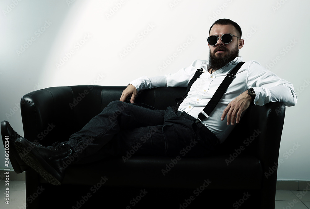 young handsome man with big beard and black sunglasses on white background young handsome man with big beard and black sunglasses on white background