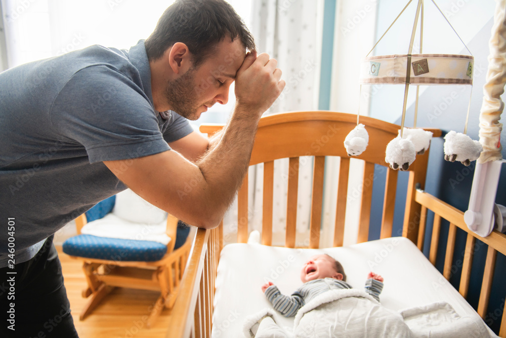 Tired father with Upset Baby Suffering with Post Natal Depression. Tired father with Upset Baby Suffering with Post Natal Depression.