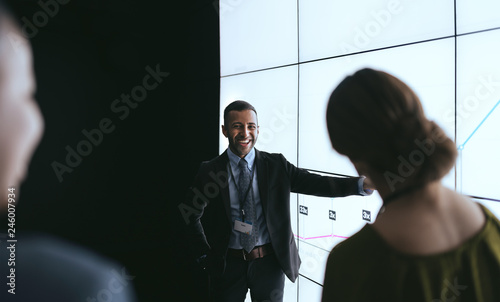 Indian businessman pointing at digital screen during a presentation