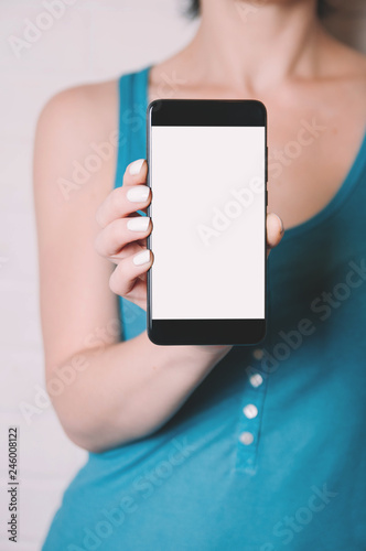 A woman holding a smartphone in her hands. Template for design or app