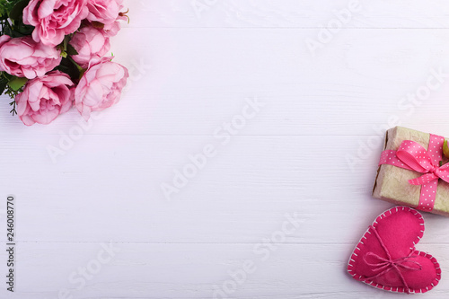 Pink felt heart, flowers and handmade gift on a white wooden table, Concept, banner, save space.