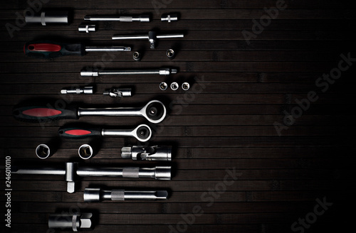 set of spanner wrench for professional car repair on a black wooden background