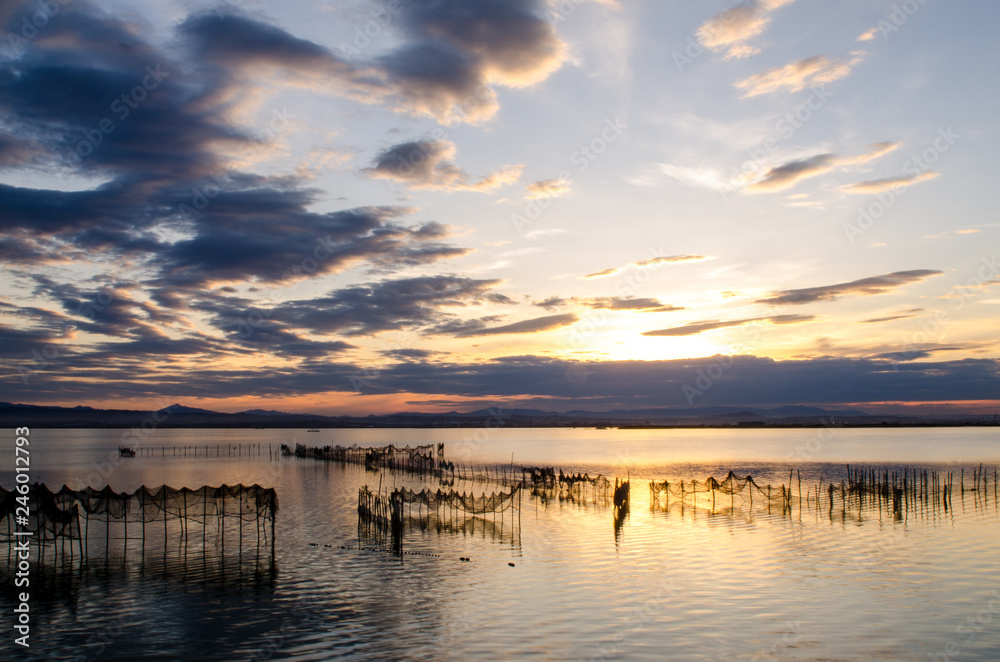 Sunset on one day cloudy in the famous lake of the albufera of Valencia, Spain.