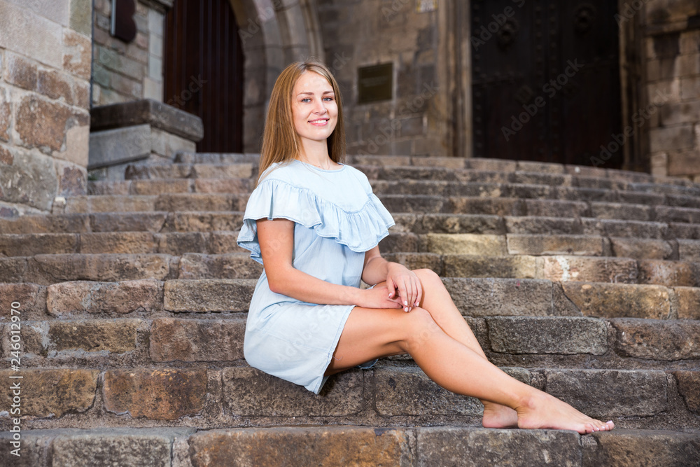 Girl sitting on stairs of temple