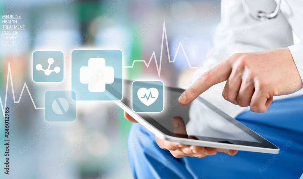Male doctor using digital tablet, close up on hands Male doctor using digital tablet, close up on hands