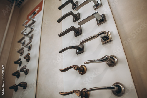 Showcase with door handles in modern shop of doors hardware