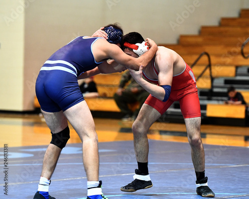 Konstfotografi High School wrestlers competing at a wrestling meet.