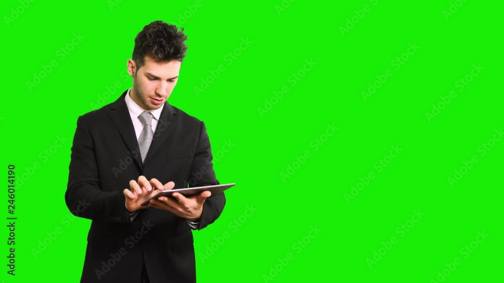Young manager using a digital tablet isolated on green screen chroma key Young manager using a digital tablet isolated on green screen chroma key