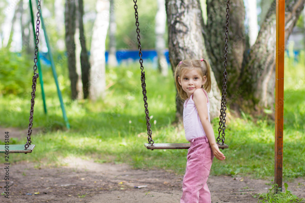 little girl on swing in the park little girl on swing in the park