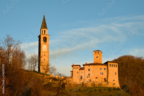Bell tower and Savorgnan Castle during the sunset in Artegna, Friuli, Italy photo