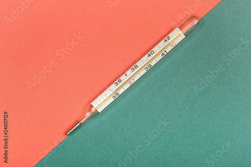 Medical mercury thermometer, Living Coral, trendy color 2019 background.  Free space for text.