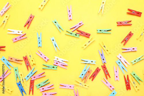 Colorful clothespins on yellow background