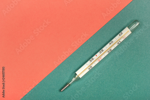 Medical mercury thermometer, Living Coral, trendy color 2019 background.  Free space for text.