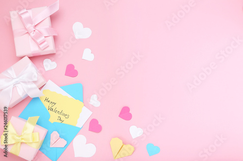 Inscription Happy Valentine Day with gift boxes and envelope on pink background © 5second