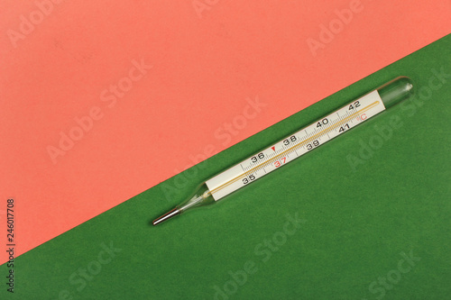 Medical mercury thermometer, Living Coral, trendy color 2019 background.  Free space for text.