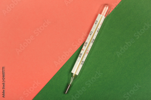 Medical mercury thermometer, Living Coral, trendy color 2019 background.  Free space for text.