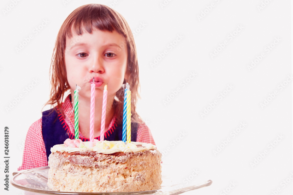 Beautiful adorable child girl blowing out the candle on her birthday cake. Copy space for designer. Holiday, happy childhood and birthday concept. Beautiful adorable child girl blowing out the candle on her birthday cake. Copy space for designer. Holiday, happy childhood and birthday concept.