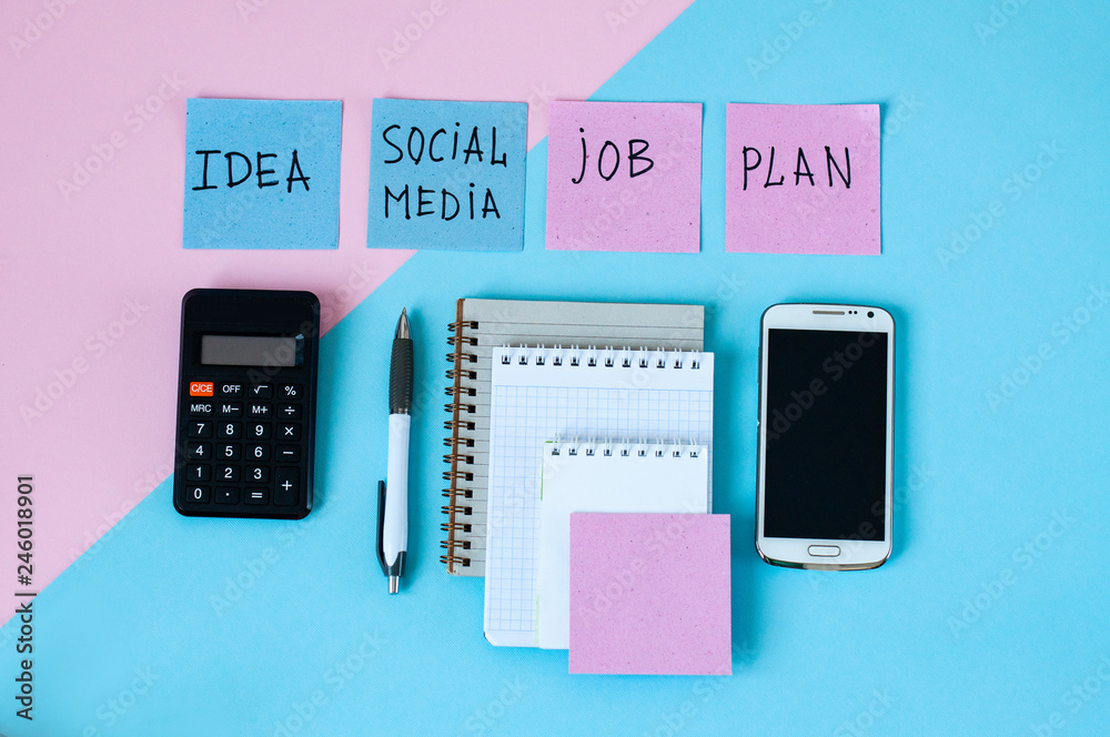 Notepad, smartphone and calculator, stationery on blue background, business records, business concept Notepad, smartphone and calculator, stationery on blue background, business records, business concept