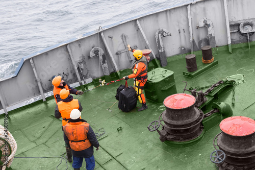 seamen carry out a rescue operation on the deck of a ship