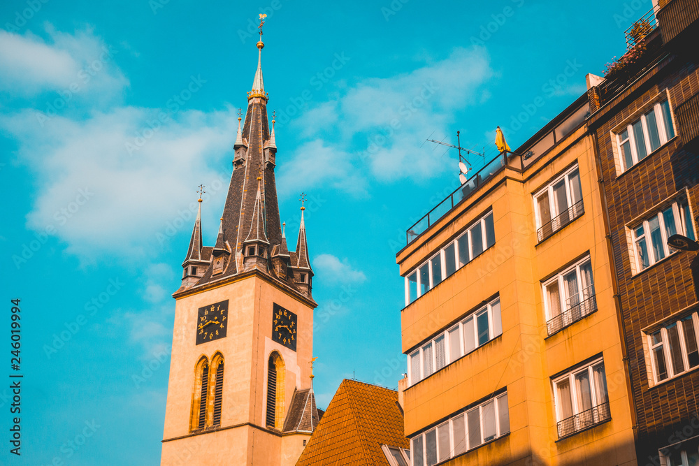 Obraz premium typical church building next to an apartment house at prague