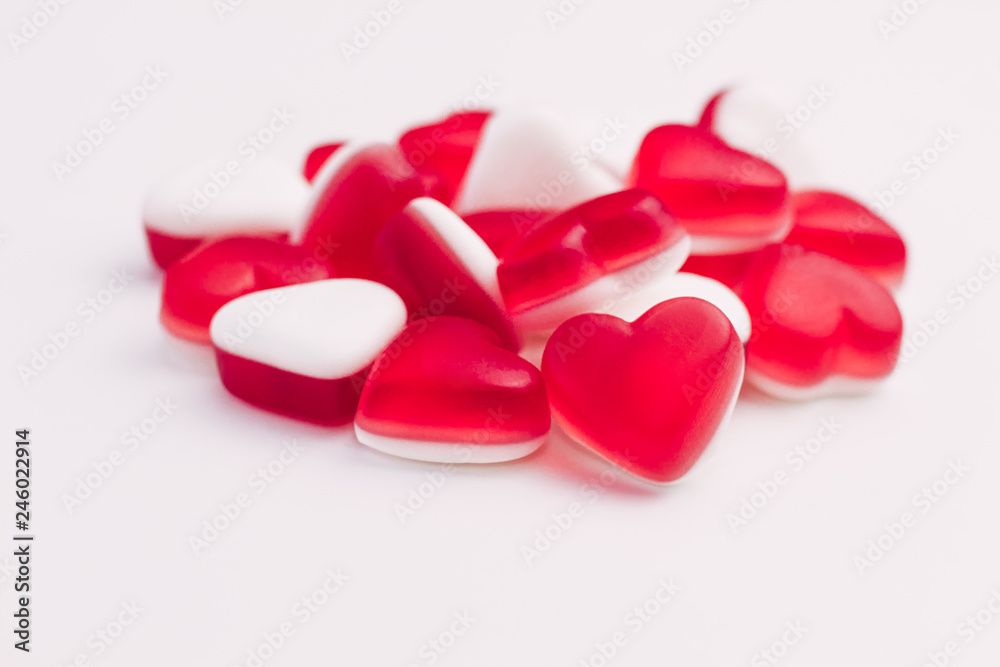 Pile of heart shaped red and white jelly sweets on white background. Place for text. Pile of heart shaped red and white jelly sweets on white background. Place for text.