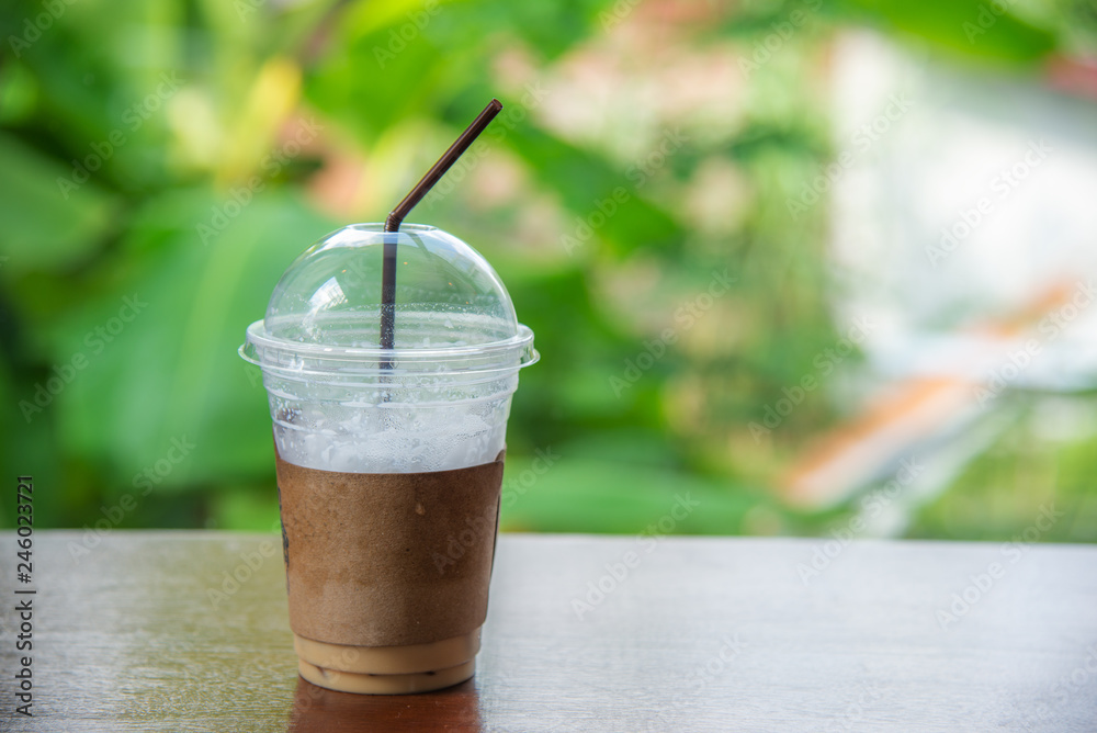 Cappuccino ice coffee in a glass on blurred bokeh Cappuccino ice coffee in a glass on blurred bokeh