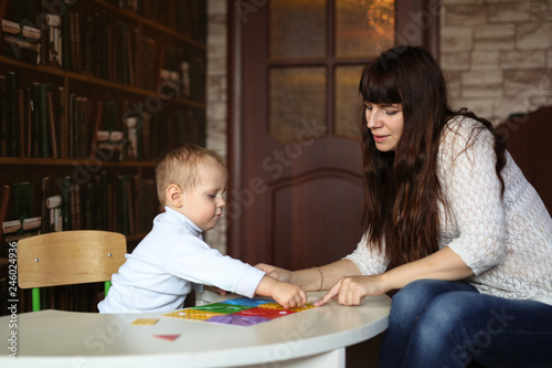 Cute woman and boy playing educational toys