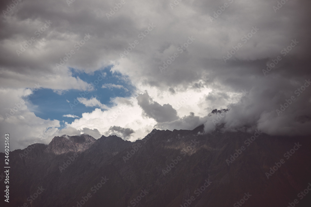 White clouds over the tops of the mountains