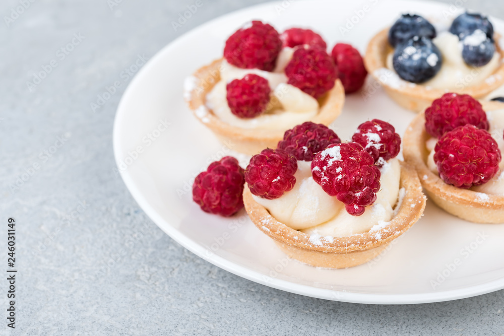 tartlets or cake with cream and berries. Pastry dessert. tartlets or cake with cream and berries. Pastry dessert.