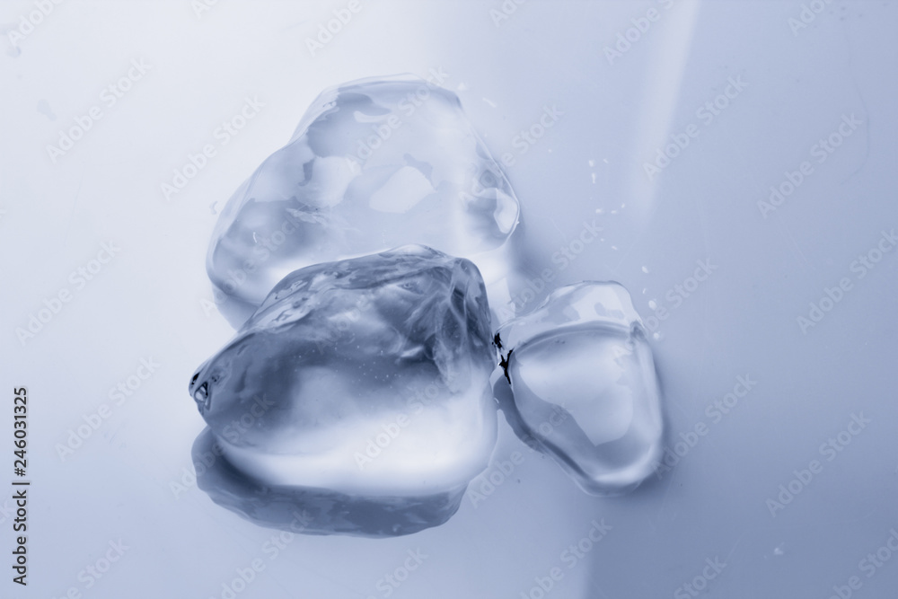 Ice cube melts in studio: Global warming concept Ice cube melts in studio: Global warming concept