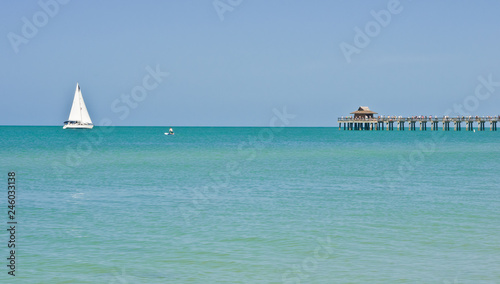 Obraz na plátně Front view, very long distance of a sailing vessel, under sail moving along trop
