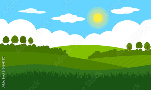 Rural landscape landscape. Green fields  meadows  bushes and trees against the blue sky with clouds and the bright sun.