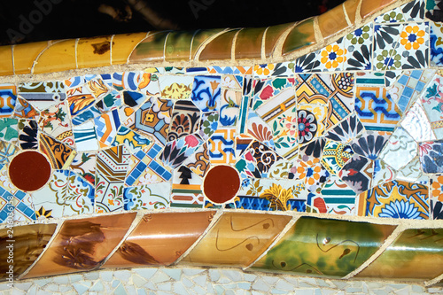 Details of trencadis mosaic of the ceramic serpentine bench at the central terrace of Park Guell designed by Antoni Gaudi, Barcelona, Spain.