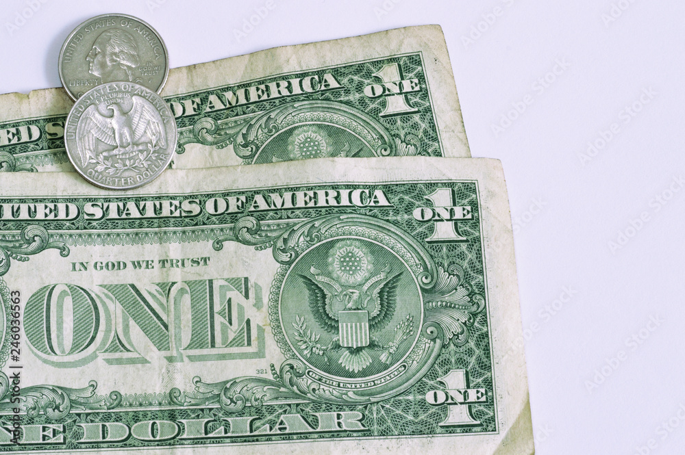 one dollar bills and quarter coins on the left of the scene one dollar bills and quarter coins on the left of the scene
