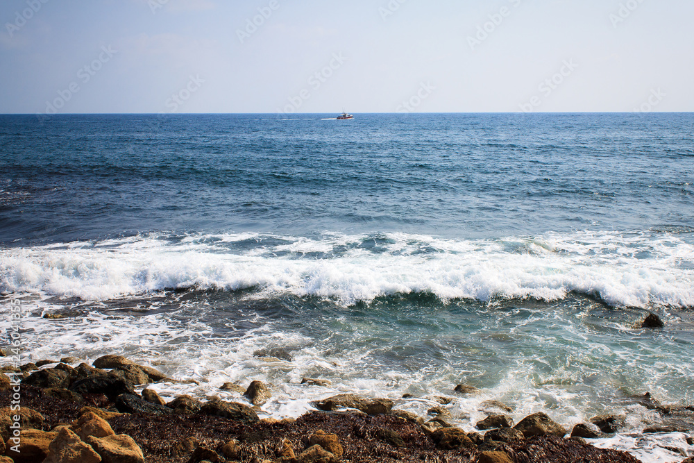 Waves of the Mediterranean Sea crashing on the rocky coast of the island of Cyprus