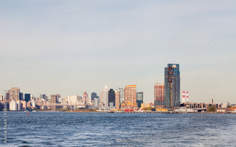 The view across the East River towards Hunter's Point South in Long Island City, New York City. Roosevelt Island and Queensboro Bridge passing over the island can also be seen. The view across the East River towards Hunter's Point South in Long Island City, New York City. Roosevelt Island and Queensboro Bridge passing over the island can also be seen.
