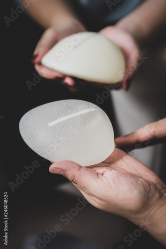 Plastic surgeon and patient discuss choice of breast implants after mastectomy or for breast augmentation. 
