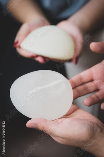 Plastic surgeon and patient discuss choice of breast implants after mastectomy or for breast augmentation. 
