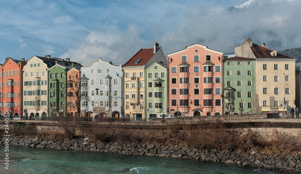 INNSBRUCK, AUSTRIA - JANUARY, 01 2019: Panoramic view of the historic city center of Innsbruck with colorful houses along Inn river and famous Austrian mountain in the background - Tyrol, Austria
