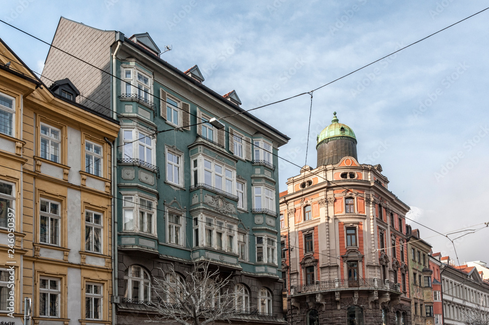 Fototapeta premium INNSBRUCK, AUSTRIA - JANUARY, 01 2019: The ornate and colourful buildings in the famous Maria Theresien Strasse in the old city center of Innsbruck, the Austrian Alpine town - Austria